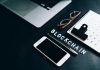 Blockchain vs. Digital Yuan: The Path to Currency Digitalization Flat lay of a modern digital workspace with blockchain theme, featuring a smartphone and calendar.
