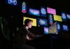Top Benefits of Using a Mythic Boost Service in WoW A focused gamer plays e-sports in a neon-lit room, surrounded by digital screens.