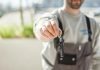 Nevada’s Insurance Laws and Rental Cars: What to Know Before You Drive Hand holding a car key outdoors, blurred background, shallow focus.