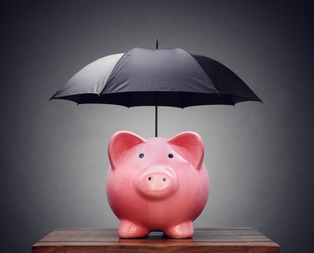 A black umbrella over a piggybank