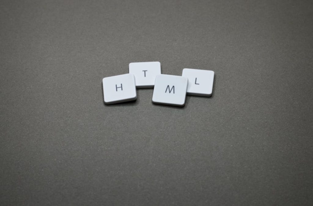 A group of small square white buttons with letters Description automatically generated