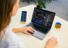 Omega Global Plus Expands Across Europe with a Bold Focus on Crypto Trading in 2025 a woman sitting at a table using a laptop computer