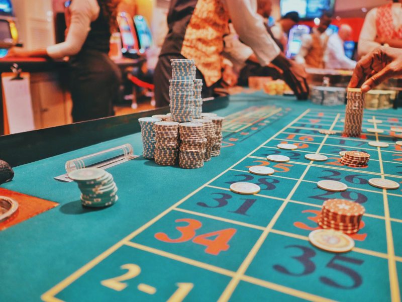Photo by Kaysha a casino table with a lot of chips on it