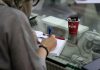 Scoring Big: How IELTS Paves the Way for a Sports Career Abroad a person working on a machine