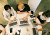 5 Big Benefits to Hiring a Fractional CMO Top view of diverse team collaboratively working in a modern office setting.
