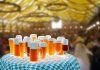 Unique Beer Traditions Around the Globe a table topped with lots of glasses of beer