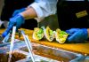 10 Important Strategies for Food Safety Compliance person about to put sauce on tacos
