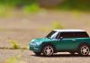 Car Loan EMI Calculator: Simplify Your Loan Planning Green toy Mini Cooper car on pavement featuring a shallow depth of field outdoors.