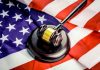How to Successfully Defend Yourself Against Federal Charges a judge's gavel on top of a flag