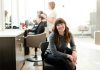 How Can Salon Owners Support Their Staff in Achieving Work-Life Balance? woman in gray long sleeve shirt and black pants sitting on black chair
