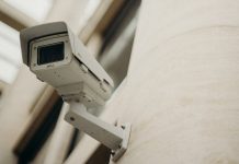 What to Expect from a Professional CCTV Installation Service Close-up of a security camera on a building wall, showcasing surveillance technology.