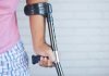 7 Tips for Returning to Work After an Injury a person holding a crutch and walking cane