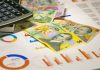 Why a Personal Loan Calculator Is a Game Changer for Borrowers A calculator sitting on top of a pile of money