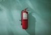 What’s Really Protecting Your Building? The Hidden Flaws In Fire Safety Most Owners Miss red fire extinguisher on green wall