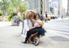 4 Jobs to Consider That Help You Balance Work and Family Life woman in white dress shirt holding her daughter in tutu dress beside of asphalt road during daytime
