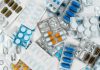 The Convenience of Online Prescriptions: Managing Your Medications from Home a pile of pills sitting next to each other on top of a table