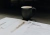 Effective Approaches to Property Tax Reassessment Appeals coffee mug near open folder with tax withholding paper