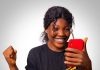 Instinct or Analysis: Which One Leads to Better Decisions? A cheerful woman celebrates success while looking at her smartphone, expressing happiness.