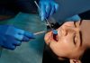 5 Signs You Should See a Dentist—Even If Your Teeth Don’t Hurt Close-up of a dentist examining a patient's teeth using dental tools.