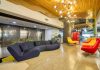 Designing Offices That Speak Global Operate Local1 black leather couch beside yellow plastic bucket