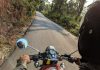 8 Steps To Take After A Motorcycle Crash In Henderson Motorcyclist riding on a scenic forest road, capturing adventure and freedom.