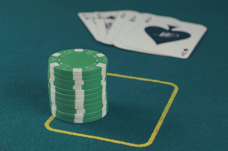 Photo by Michał Parzuchowski green poker chips on table