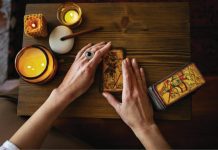 Can a Medium Reading Help You Find Closure? A person sitting at a table with a cell phone