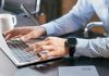 How To Create a Digital Product to Sell: A Complete Guide A person typing on a laptop at a desk