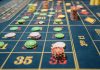 The Impact Live Casino Gaming Has Had on the Market Close-up of a roulette table with colorful poker chips, capturing the thrill of casino gambling.