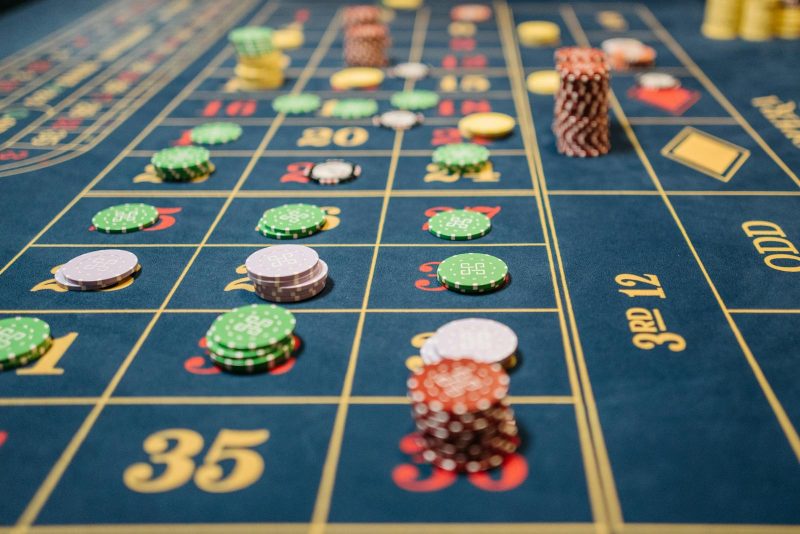 Photo by Pavel Danilyuk Close-up of a roulette table with colorful poker chips, capturing the thrill of casino gambling.