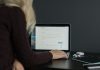 9 Best Free Dark Mode WordPress Themes in 2025 woman in black sweater using macbook pro
