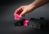 How Private Mortgage Insurance (PMI) Works A hand reaching for a pink house in front of a row of houses
