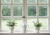 5 Reasons to Install Replacement Windows in Your Home white teapot and tow flower vases on windowpane
