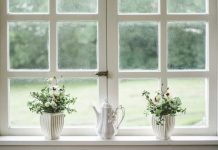5 Reasons to Install Replacement Windows in Your Home white teapot and tow flower vases on windowpane