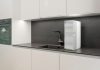 Understanding Filtration Cartridges and Their Role in Water Purification a kitchen with a sink and refrigerator
