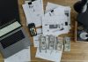 Settlement Calculator Mistakes: 7 Critical Errors That Could Cost You Thousands Overhead view of financial documents, cash, and technology on a wooden desk.
