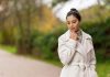 How to Care for Your Women’s Cashmere Coat to Make It Last a woman in a white coat standing on a road