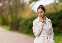How to Care for Your Women’s Cashmere Coat to Make It Last a woman in a white coat standing on a road