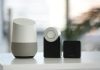 white and gray Google smart speaker and two black speakers