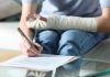 Common Mistakes That Reduce Your Personal Injury Compensation Disabled woman with bandaged arm signing document
