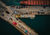 3 Ways Modern Transportation Management Elevates Supply Chain Efficiency An aerial view of a cargo ship docked at a dock