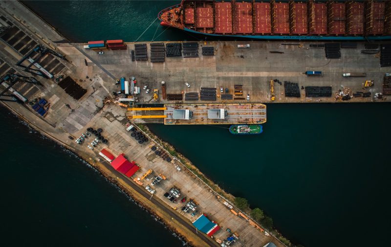 Photo by Jahanzeb Ahsan An aerial view of a cargo ship docked at a dock