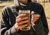 Alcohol Advertising and Its Influence on Teen Drinking a woman holding a glass of beer in her hands