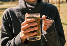 Alcohol Advertising and Its Influence on Teen Drinking a woman holding a glass of beer in her hands
