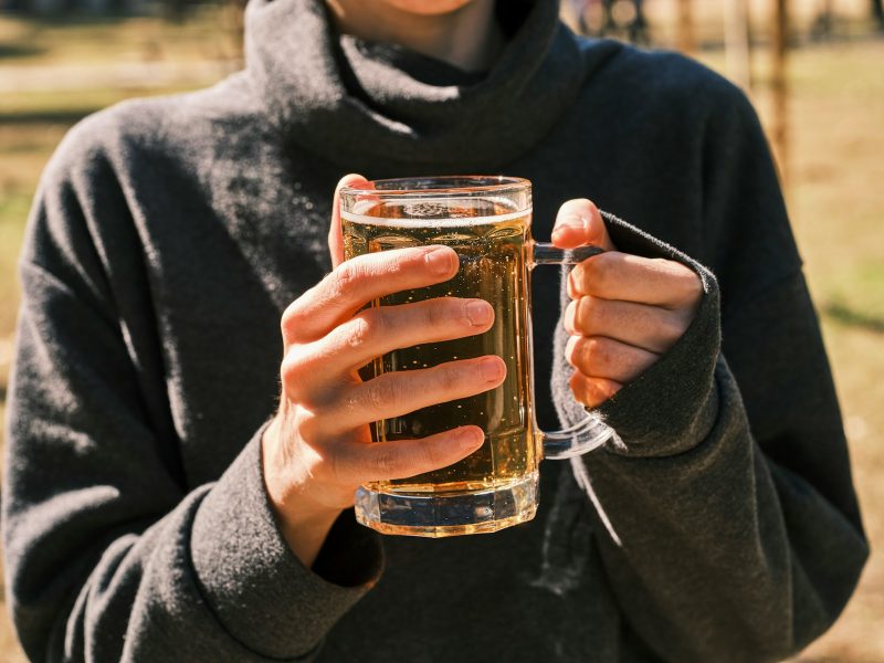 Photo by engin akyurt a woman holding a glass of beer in her hands
