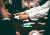 Why the Classics Still Rule the Table An intense poker game featuring players and poker chips on the table in an indoor setting.