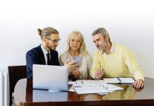Term Insurance Plan Meaning: A Simple Guide for Beginners Three individuals collaborating on financial documents during a business meeting.
