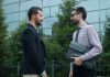 What is a Contractual Relationship? Two businessmen talking outside modern building
