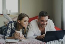 The Hidden Logic Behind Free Spins in Online Gaming Couple looking at a laptop on a bed