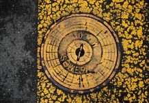 5 Telltale Signs Your Home’s Sewer System is in Trouble Yellow and black pavement surrounds a sewer cover.